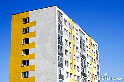 Renovated and insulated multistorey apartment building against a blue sky background Stock Photo