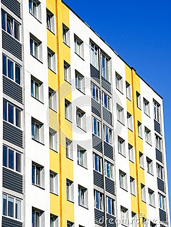 Renovated and insulated multistorey apartment building against a blue sky background Stock Photo