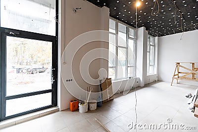 renovated room with shopping window - empty store shop with wooden floor and white walls Stock Photo