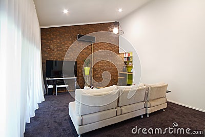 Renovated 70s exposed brick wall apartment living room Stock Photo