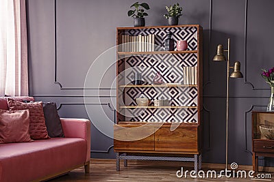 Renovated wooden bookcase with geometrical pattern and a brass f Stock Photo