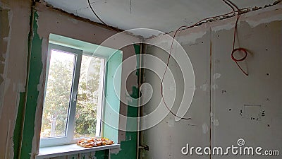 Renovation of the apartment, view of the ceiling and window, plastered walls Stock Photo