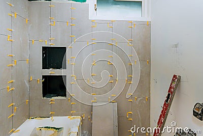 Renovation construction laying floor and wall tile reconstruction of bathroom Stock Photo