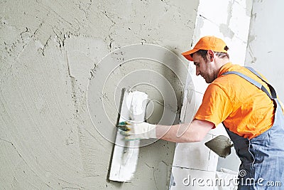Renovation at home. Plasterer spreading plaster on wall. Stock Photo