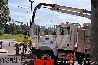 Renovation works in the city. Workers use high-pressure compressed air and water from a specialized vehicle Editorial Stock Photo