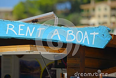 RENT A BOAT wooden sign Stock Photo