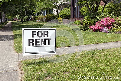 FOR RENT sign posted in lawn Stock Photo