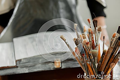 Repainting of furniture, artistic tools in the foreground, wooden casket in the back in defocus Stock Photo