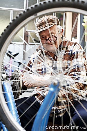 Repair of bicycles hobby is an older man Stock Photo