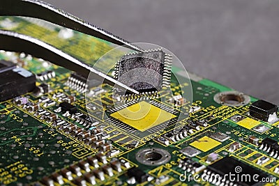 repair of the computer motherboard, soldering the microchip with a soldering hairdryer Stock Photo