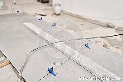 Tiler work. Repair of the dining room in the house, place for kitchen, floor covering change. Empty interior for design Stock Photo