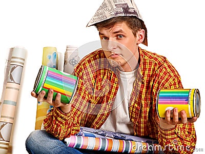 Repair home man holding paint roller for wallpaper. Stock Photo