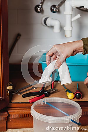 Hands hold detail of hydraulic shutter kitchen sink Stock Photo