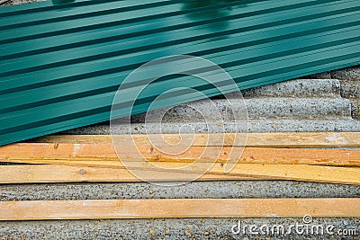 Metal profiled sheet with and wooden battens lies on old roof made of asbestos-cement sheets Stock Photo