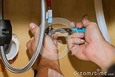 Repair in plumber installing assemble new mixer tap hands worker close up Stock Photo