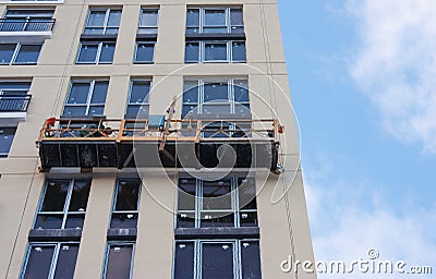 Repair and restoration of a facade of a high building. Stock Photo