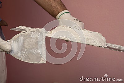 Plasterer hands at work. Applying plaster to the wall Stock Photo