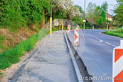 Repair of the road, installation of curbs near the carriageway. Stock Photo
