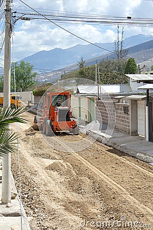 Repair of roads along Museo Solar, San Antonio, Mitad del Mundo, Quito. Transport works, a tractor, heavy machinery. 04.09.2018 Editorial Stock Photo