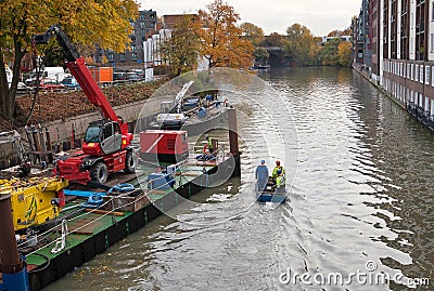Repair work on one of the many canals of Hamburg, Germany. Editorial Stock Photo