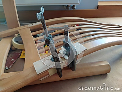 Repairing of old chair with lime and wood clamps Stock Photo