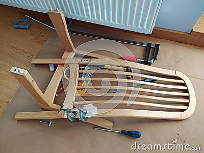 Repairing of old chair with lime and wood clamps Stock Photo