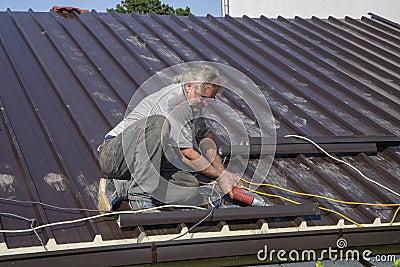 Worker roofer builder working on roof structure Stock Photo