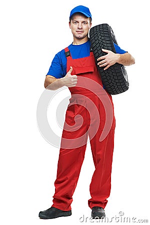 Repairman automobile mechanic with car tire Stock Photo