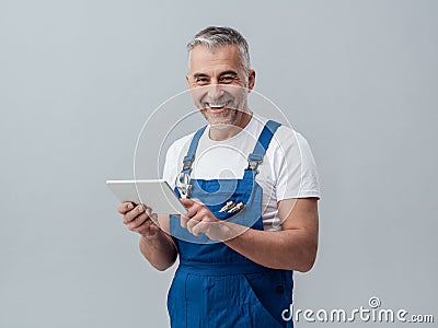 Repairman connecting with a tablet Stock Photo