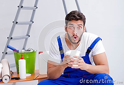 Repairman doing renovation repair in the house with paper wallpa Stock Photo