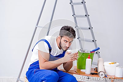 Repairman doing renovation repair in the house with paper wallpa Stock Photo