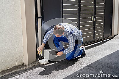 Repairman Fixing Broken Automatic Door Stock Photo