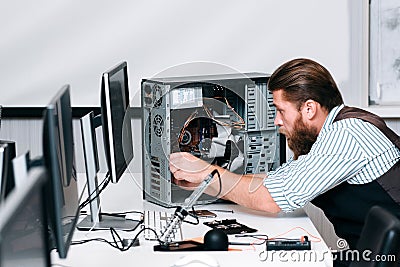 Repairman fixing components in computer unit Stock Photo