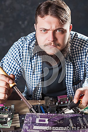 Repairman fixing problem with soldering tool Stock Photo