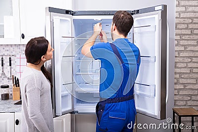 Repairman Fixing Refrigerator With Screwdriver Stock Photo