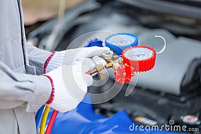 Repairman holding monitor tool to check and fixed car air conditioner system, Technician check car air conditioning system Stock Photo