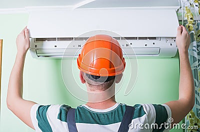 Repairman install air conditioning Stock Photo