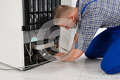 Repairman Making Refrigerator Appliance Stock Photo