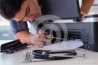 The repairman repairing broken color printer Stock Photo