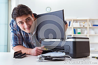 The repairman repairing broken color printer Stock Photo