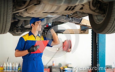 repairman and technician in car garage service in blue uniform Stock Photo