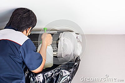 Repairman washing dirty compartments air conditioner, Male technician cleaning air conditioner indoors, Maintenance and repairing Stock Photo