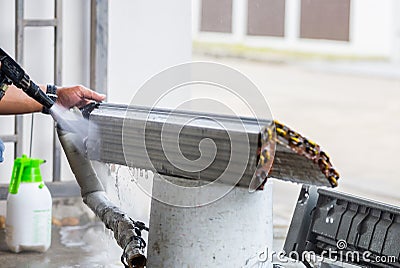 Repairman washing dirty inside compartments air conditioner, Technical team clean mold in system air conditioning system Stock Photo