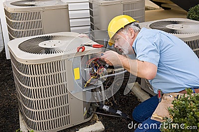 Repairman Working On Air Conditioner Stock Photo