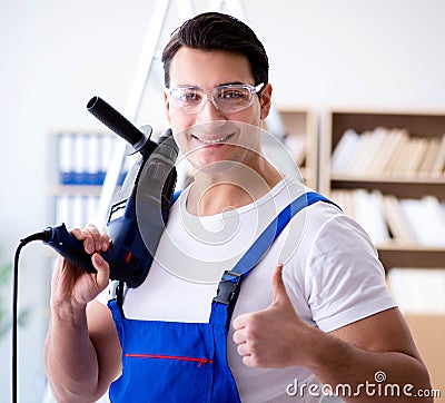 Repairman working with drilling drill perforator Stock Photo