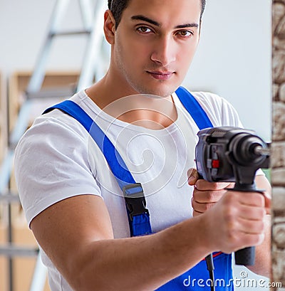 Repairman working with drilling drill perforator Stock Photo