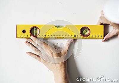 Repairman working with measuring ruler on the wall Stock Photo
