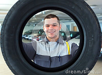 Repairmen automobile mechanic with car tire Stock Photo