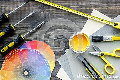 Reparing home concept. Paint and tools on wooden desk background top view Stock Photo