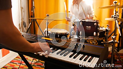 Repetition. Girl drummer and a guy on keyboards. Focus on keyboard Stock Photo